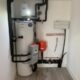 Samsung heat pump system with various connected pipes and components in a utility room.