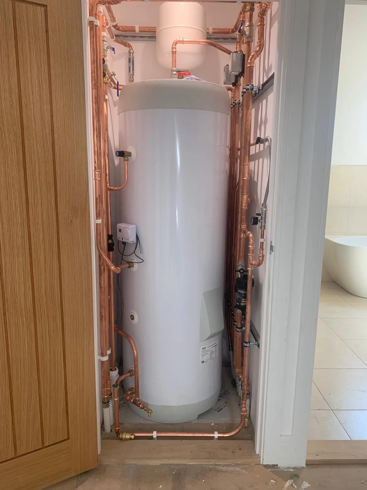Panasonic air source heat pump cylinder installed in tight airing cupboard, Diss, Norfolk