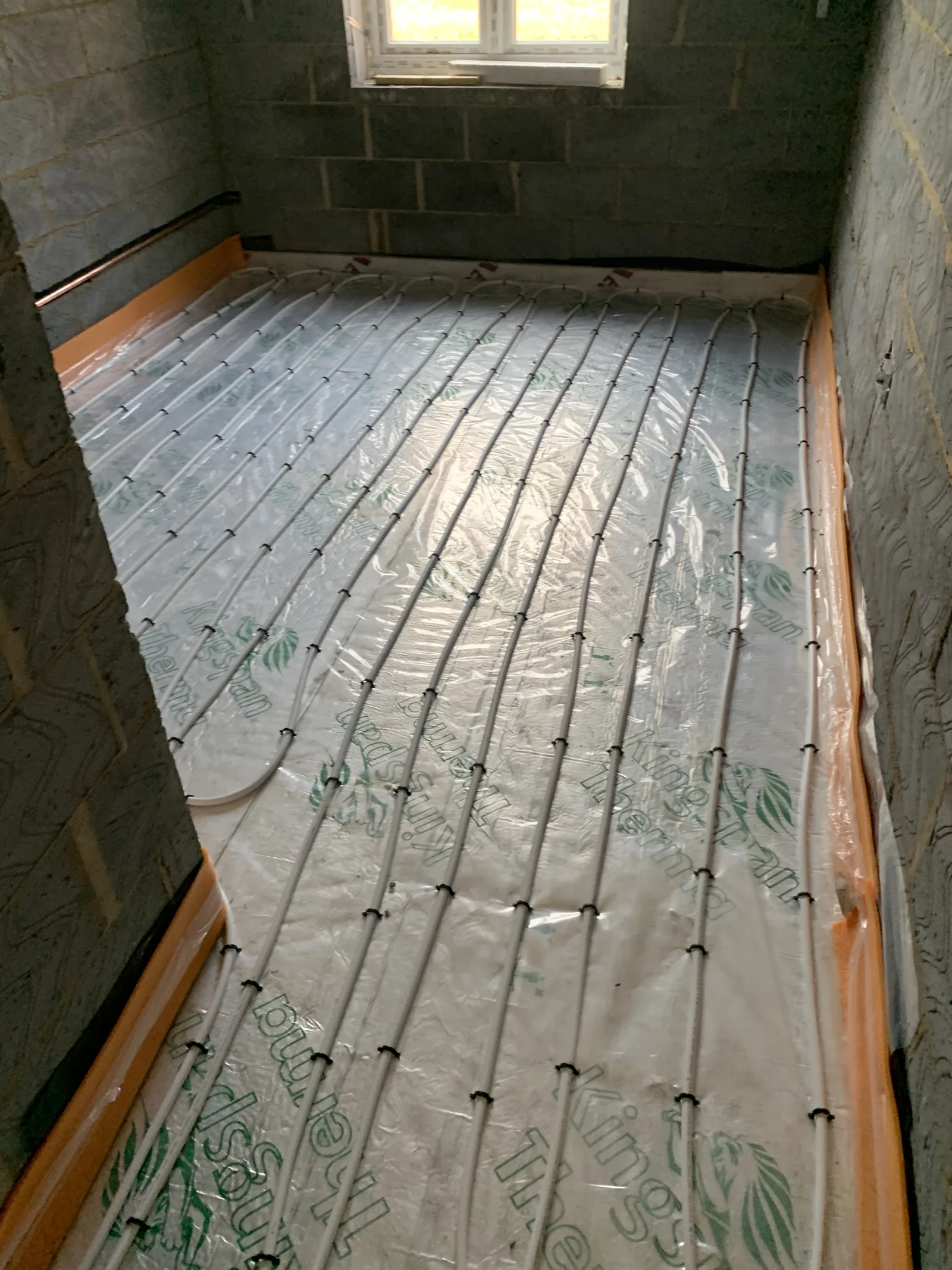 Underfloor heating pipes secured to insulation in Great Moulton bungalow floor