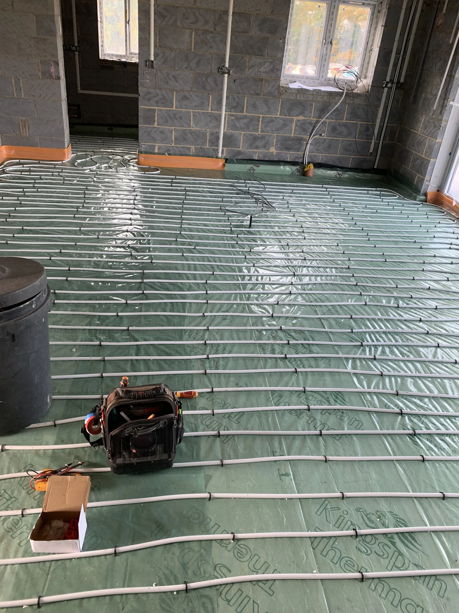 Underfloor heating pipes laid in open-plan area of Great Moulton bungalow