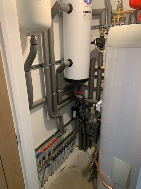 Sanitary manifold pipework for hot and cold water in new build heat pump installation, Wymondham