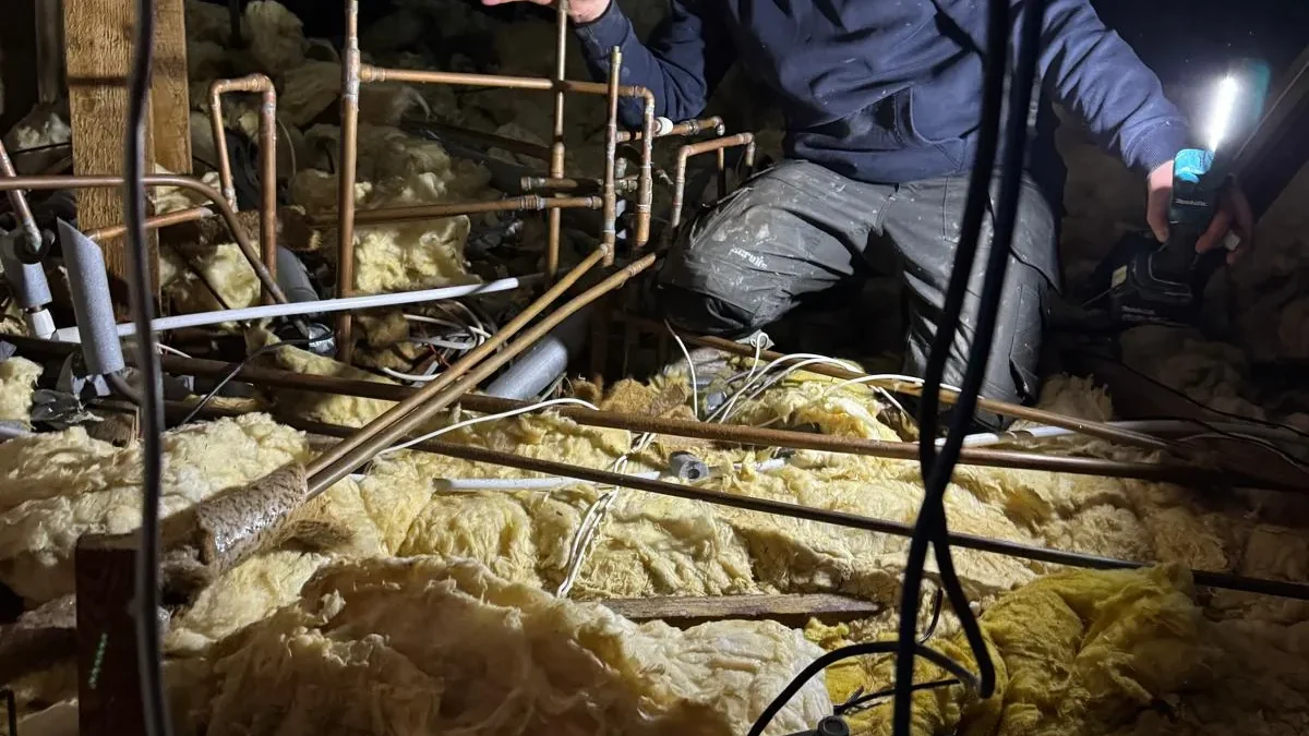 Plumber repiping loft space after frozen pipe damage in Necton Norfolk