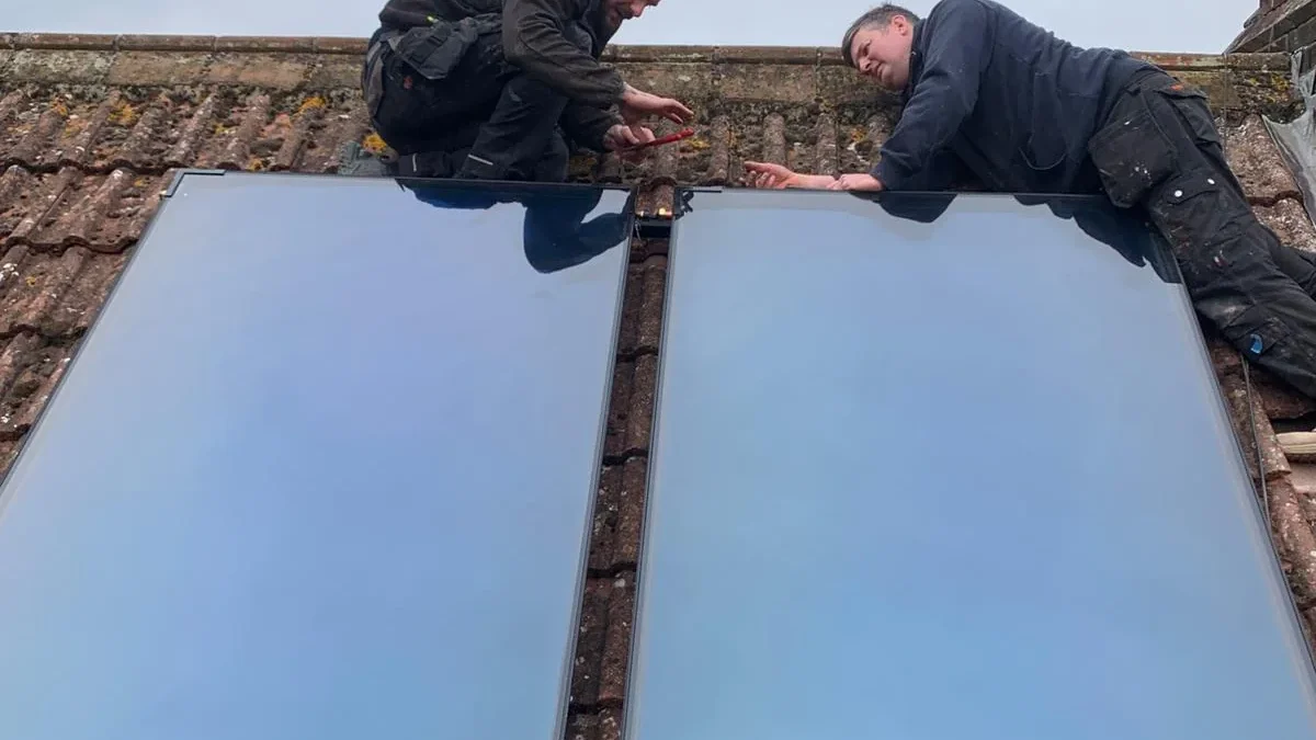 EPH Services engineers installing solar thermal panels on roof in Castle Acre Norfolk