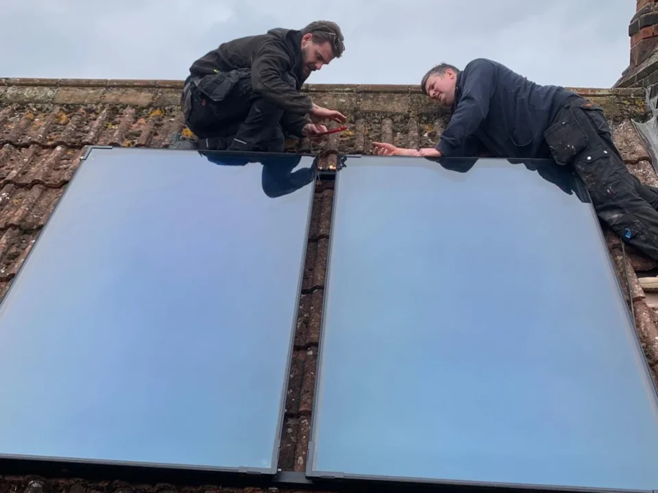 EPH Services engineers installing solar thermal panels on roof in Castle Acre Norfolk