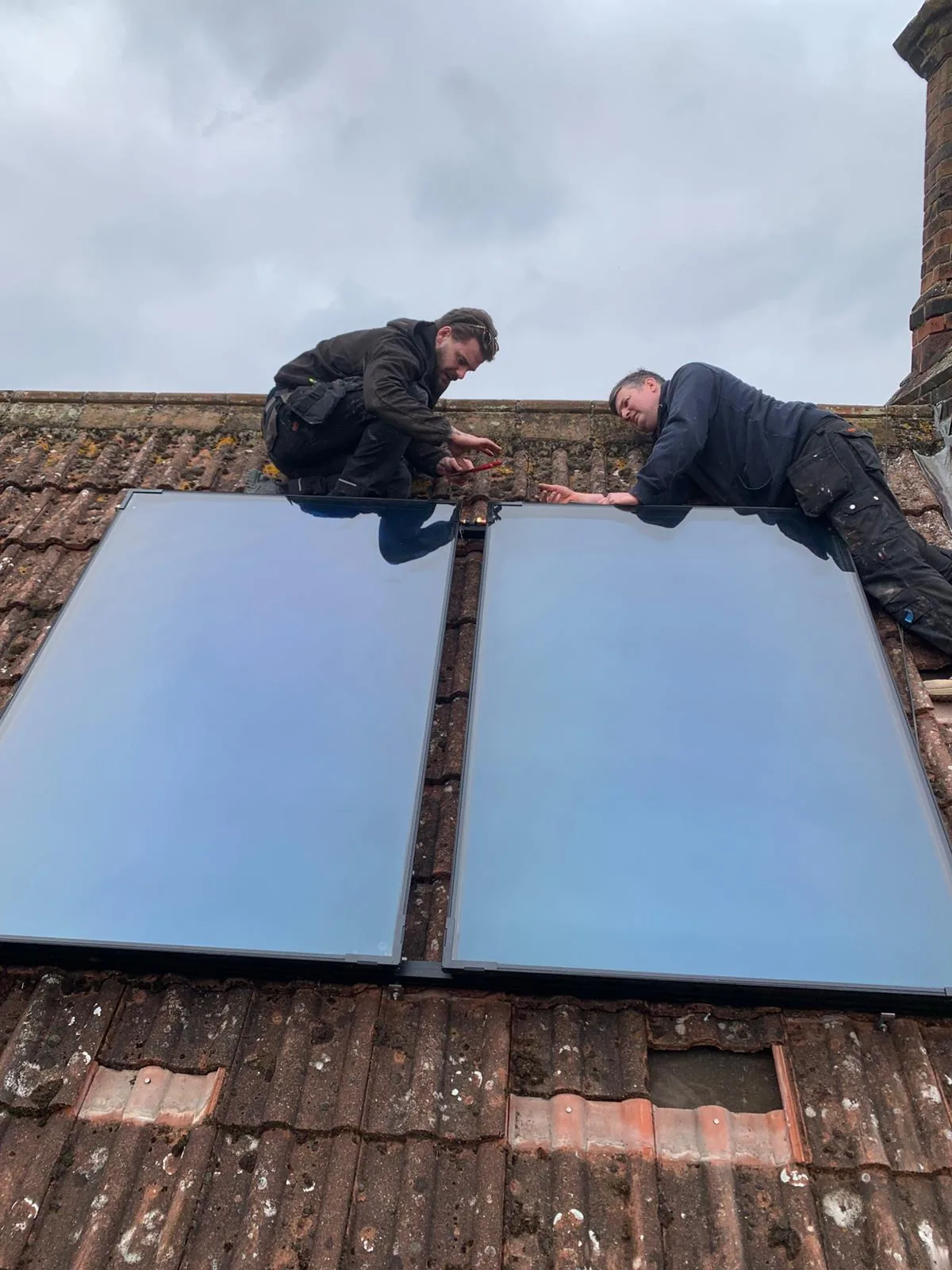 EPH Services engineers installing solar thermal panels on roof in Castle Acre Norfolk