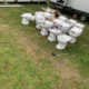 Multiple white toilet units ready for installation at camping site near King's Lynn Norfolk