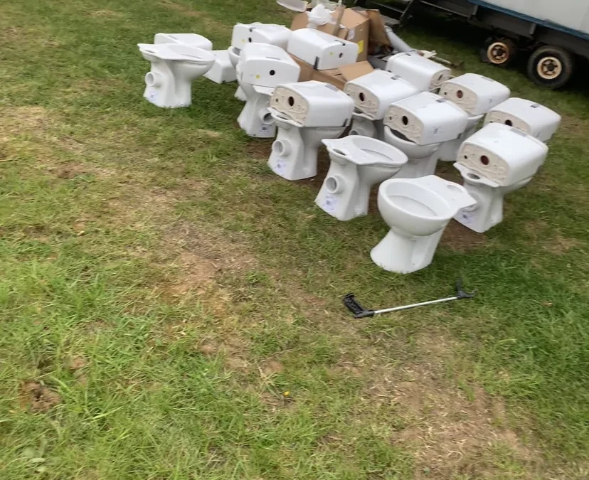 Multiple white toilet units ready for installation at camping site near King's Lynn Norfolk