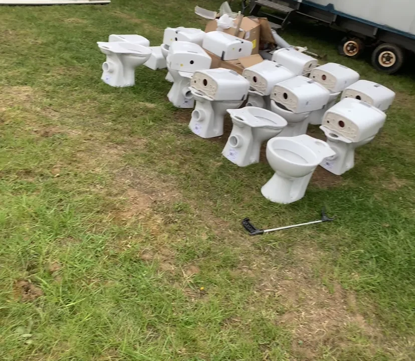 Multiple white toilet units ready for installation at camping site near King's Lynn Norfolk