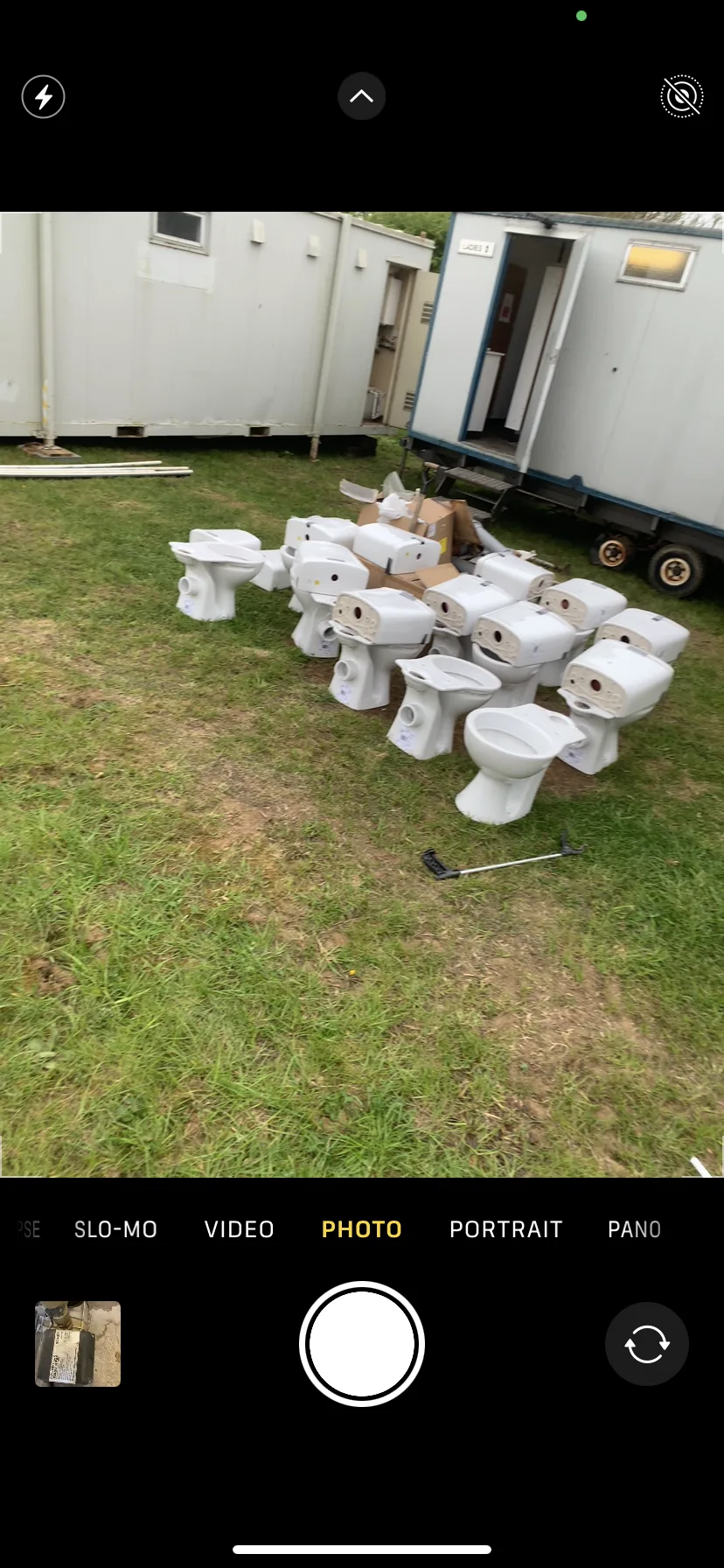 Multiple white toilet units ready for installation at camping site near King's Lynn Norfolk