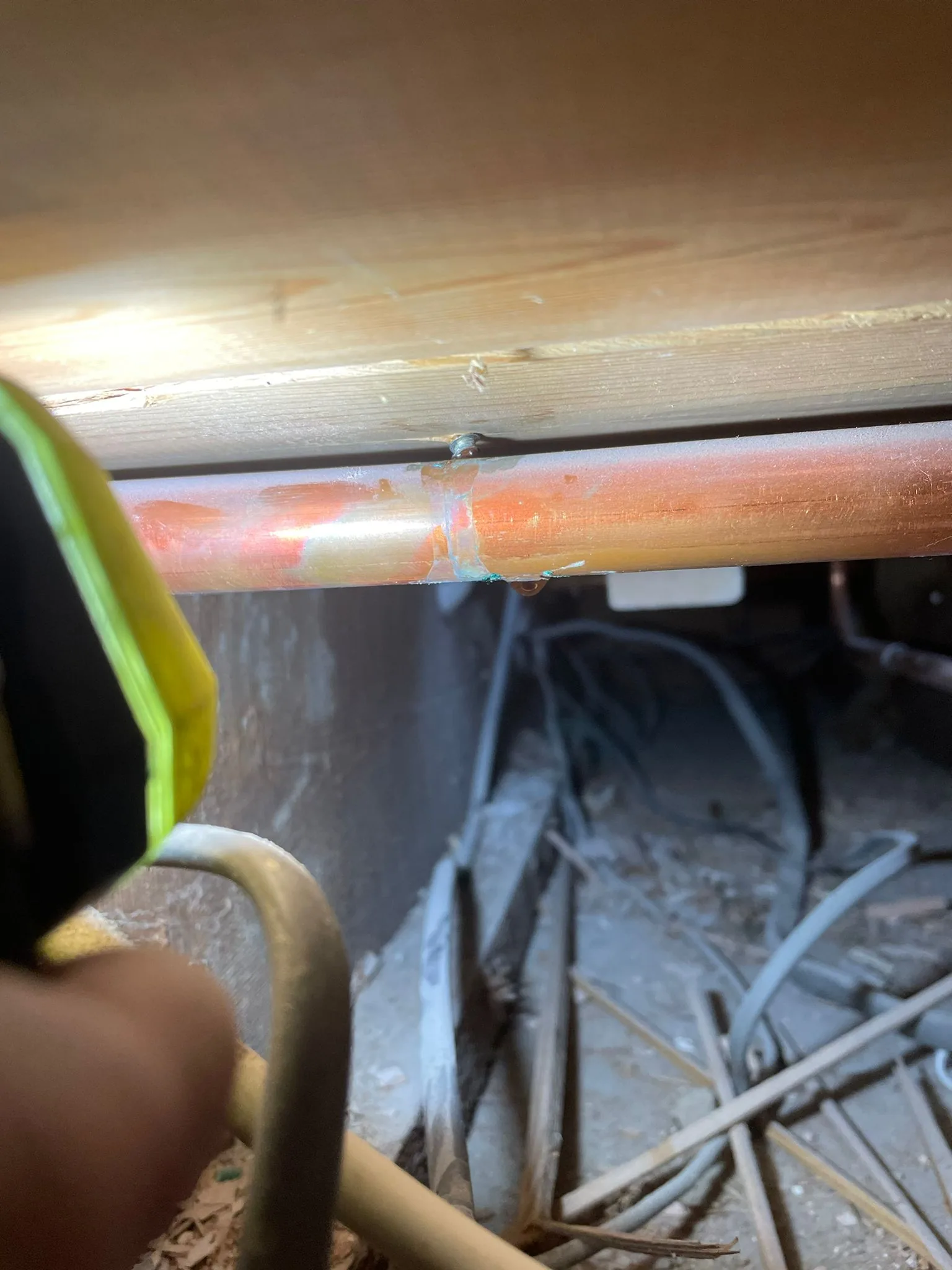 Central heating pipe leak repair in Norwich showing punctured copper pipe