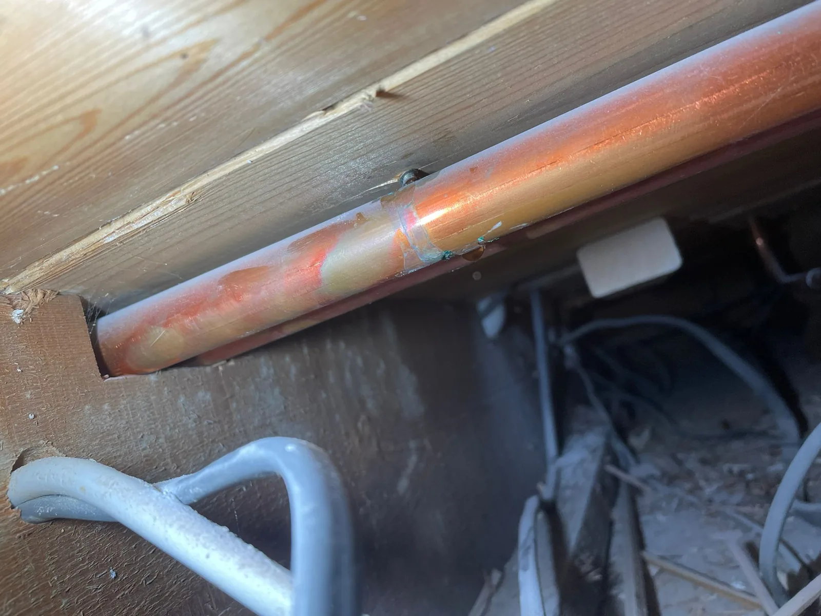 Repaired central heating pipe in Norwich showing new soldered joint