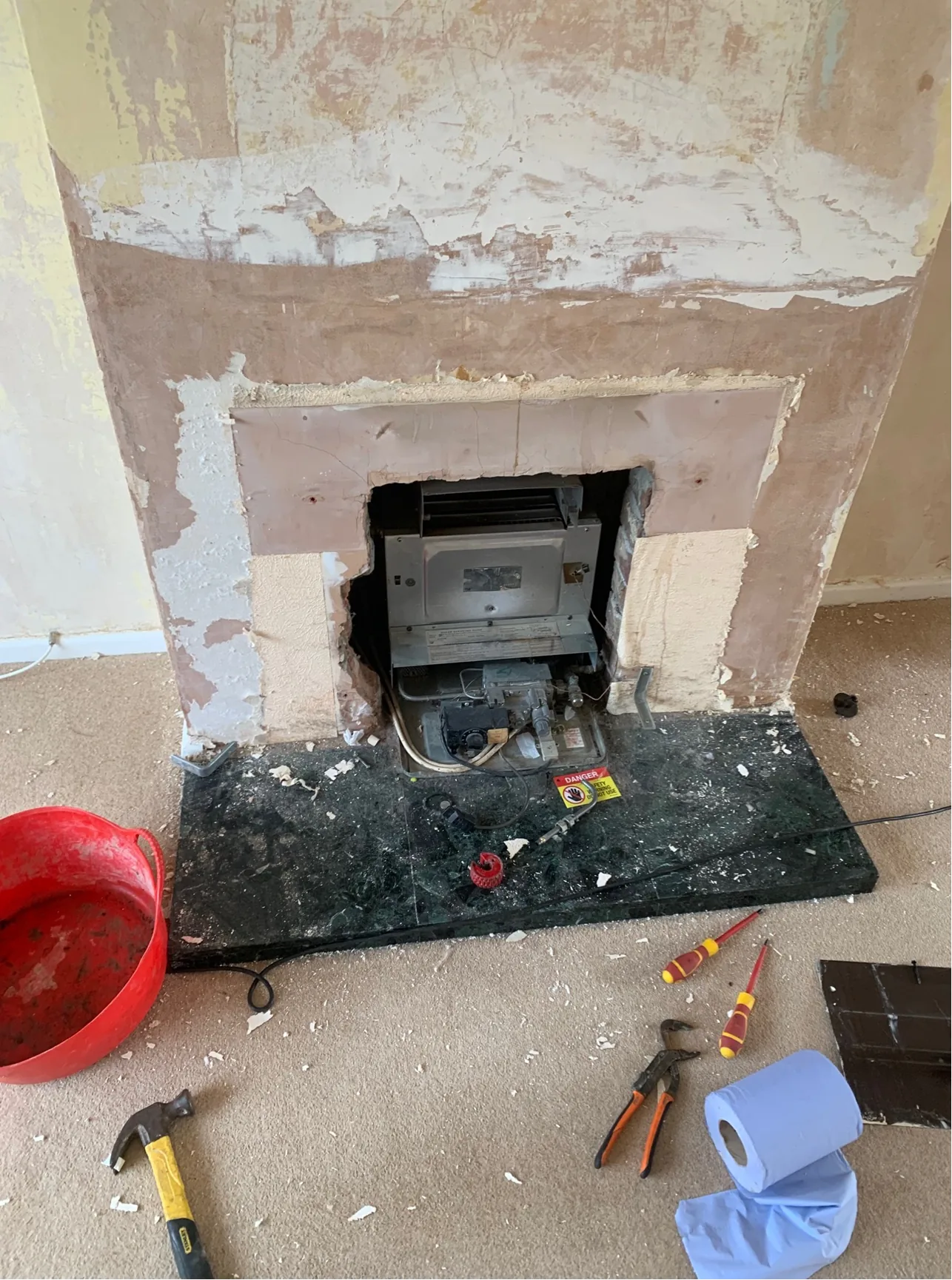 Back boiler removal King's Lynn showing exposed fireplace and old heating pipework