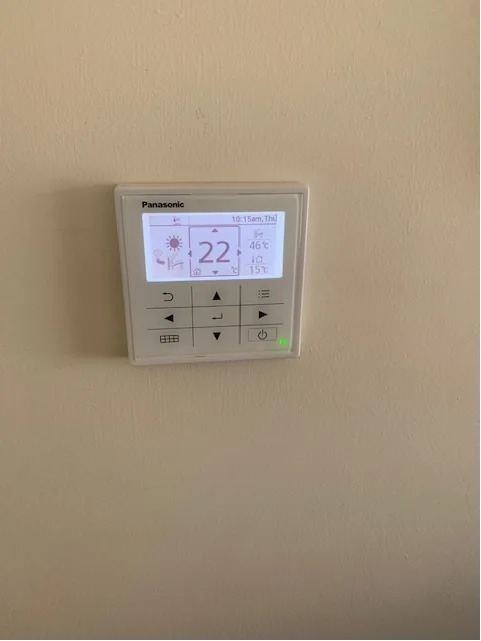 Panasonic heat pump wall controller display showing temperature in Shropham home